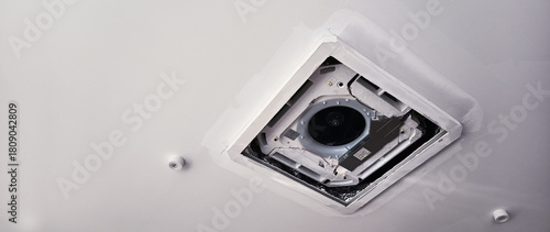 New ceiling fan duct being installed in room ceiling with sheetrock being repaired, Air conditioner repairs and installs air conditioners