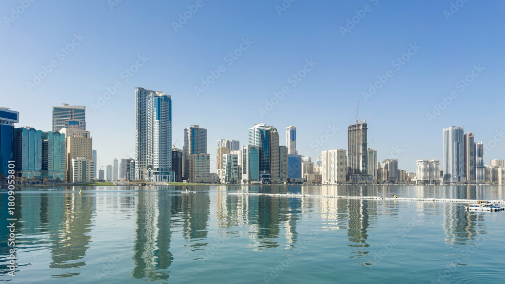 Fototapeta premium Clear morning scene view from Al Majaz Waterfront in Sharjah, UAE, open water and distant towers