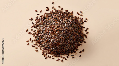 A top view of a pile of flax seeds scattered on a beige surface with soft natural lighting creating shadows christmas and happy new year background 