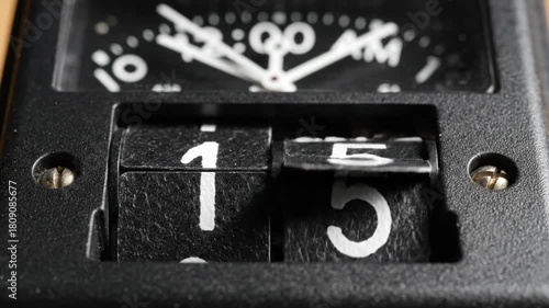 Close up of a vintage flip clock showing time 1 -17 AM.