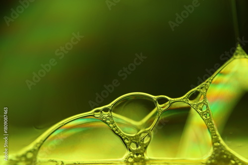 Yellow liquid surface, phenomenal structure, green oils on a dark background, colourful abstract, surrealistic art, iridescent effect