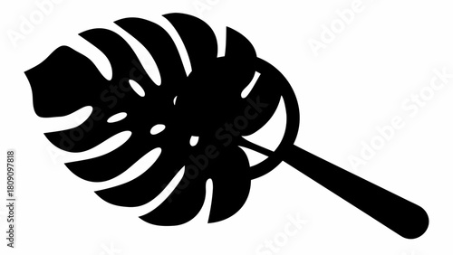 Silhouette of a monstera leaf with distinct fenestrations and a round handle attached to it design