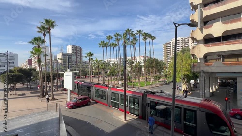 Modern red tramway in downtown Casablanca Morocco, urban public transportation with cars and buildings on a sunny day, African city travel and daily commute Casablanca train station, Morocco. 