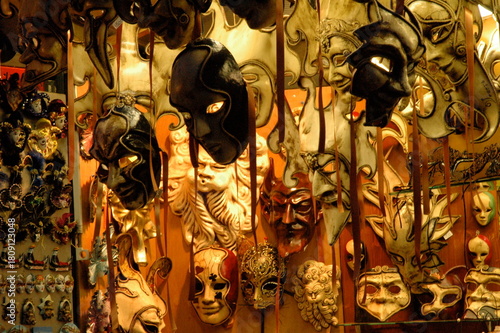 A vibrant display of Venetian carnival masks, showcasing intricate craftsmanship, bold colors, and dramatic expressions. Perfect for travel, culture, art, and festival themes.