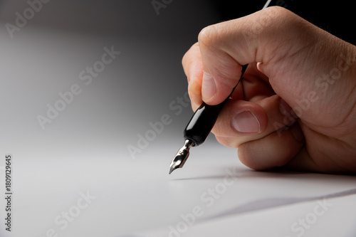 hand writes with a black pen on a clean white background with ample space for text. The hands masterfully practiced calligraphy on textured paper, surrounded by a serene atmosphere