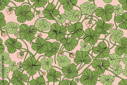 Seamless pattern of green clover leaves and small pink flowers on a light pink background shamrock