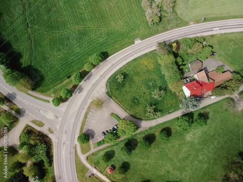 The roundabout road aerial view that newly developed. Summer sunny day. Roundabout on suburban road.