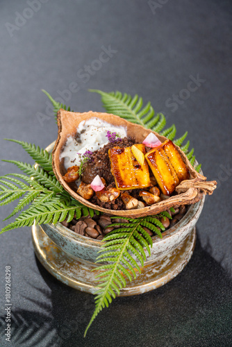 Dessert of grilled banana and chocolate is served on the table.
