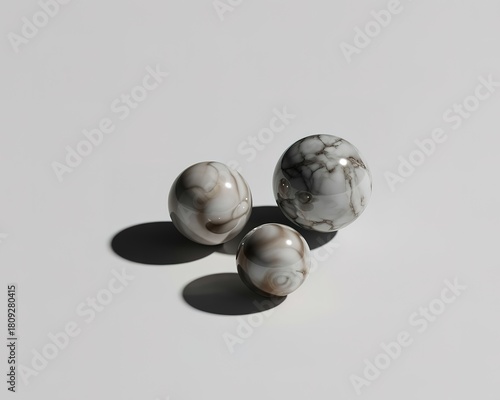 Three marbled spheres of varying sizes on a white background balls marbles