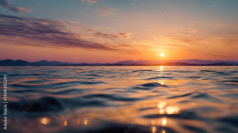 Obraz premium Serene ocean view at sunset with warm colors reflecting on the water surface and sky