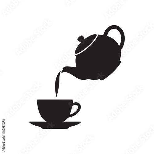 Teapot pouring tea into cup in silhouette
