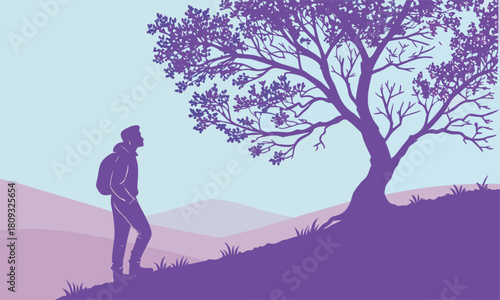 Silhouette of a person with a backpack walking uphill towards a tree.