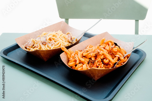 two pasta servings on an outdoor table