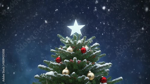 Snow falling on top of a Christmas tree
