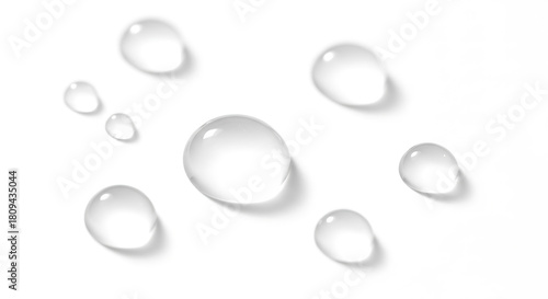 Pure water droplets glistening on a clean white surface create a sense of freshness and hydration perfect for beauty, wellness, and cleanliness concepts