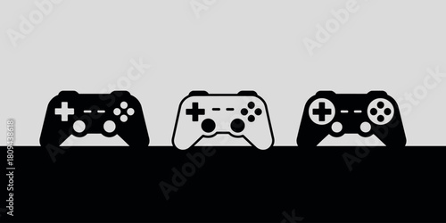 Three video game controllers in a row on a minimalist background
