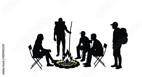 Silhouette of hikers gathered around a campfire in the outdoors