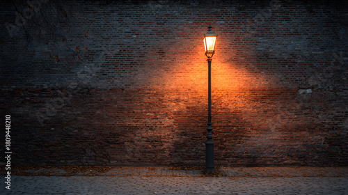 Brick wall with old streetlamp casting warm glow