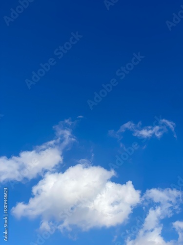 Blue sky and a single white cloud”