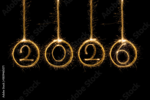 Happy New Year 2026. Burning sparkling text 2026 isolated on black background.