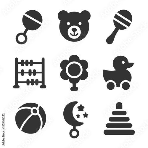 Collection of baby and toddler toys including rattles, teddy bear, and rubber duck.