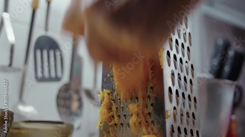 Close-up, elderly woman's hand grating pumpkin on pie grater