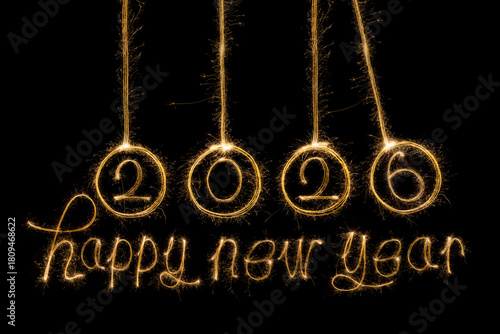 Happy New Year 2026. Burning sparkling text 2026 isolated on black background.