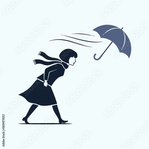 Woman walking against the wind with umbrella in stormy weather, she walks struggling against the blowing wind. Woman is depicted fighting against powerful wind,