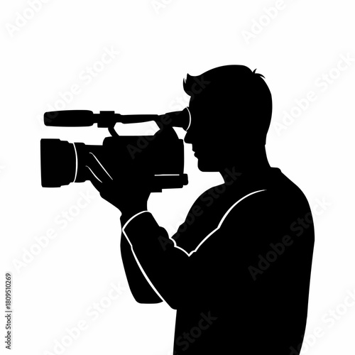 Black silhouette of a cameraman operating a professional video camera.