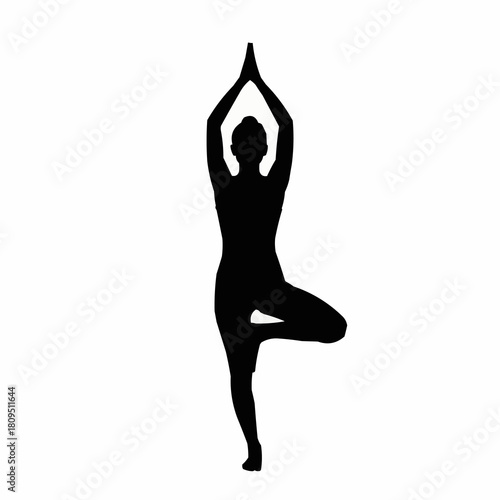 Silhouette of a woman in a yoga tree pose, balancing and focused.
