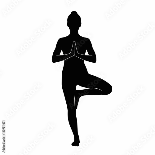 Silhouette of a woman in tree pose, a yoga posture.