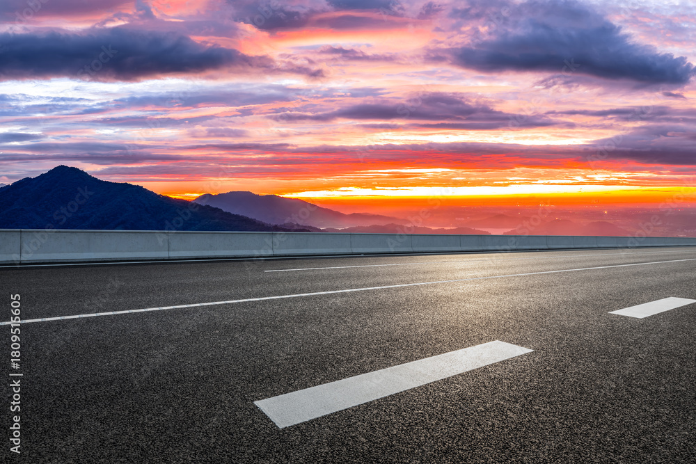 Fototapeta premium Empty asphalt highway road and mountain range with beautiful sky clouds natural landscape at sunrise