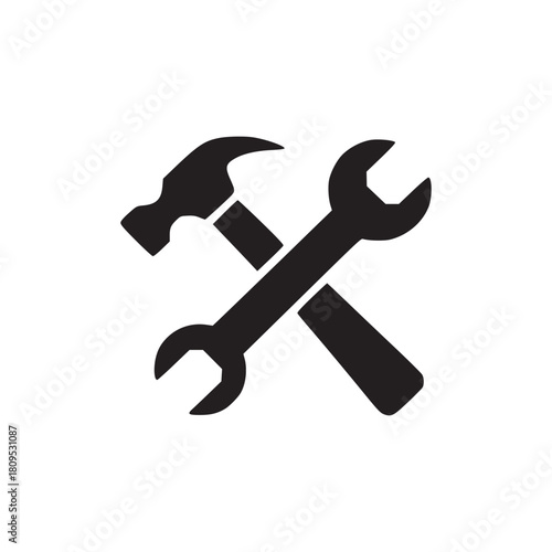 A black silhouette of a hammer crossed with a wrench on a white background in a simple design