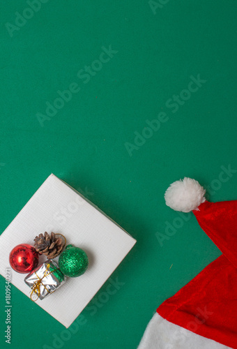 gift box with Christmas ball on a green background