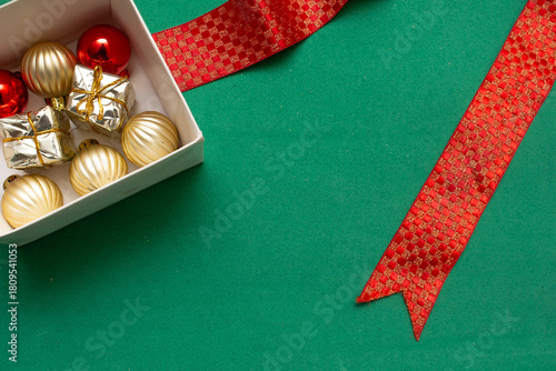 gift box with Christmas ball on a green background