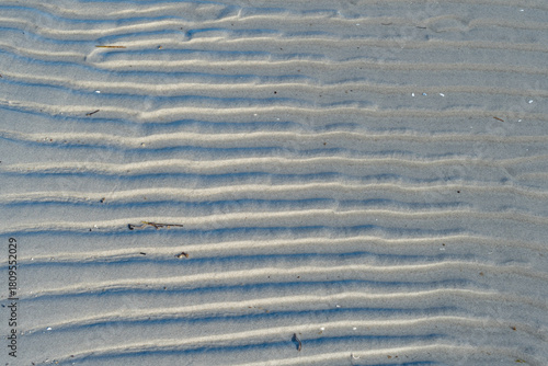 Fototapeta Naklejka Na Ścianę i Meble -  Structures on a Baltic Sea shore with blue water and soft sand creating a peaceful natural beach view