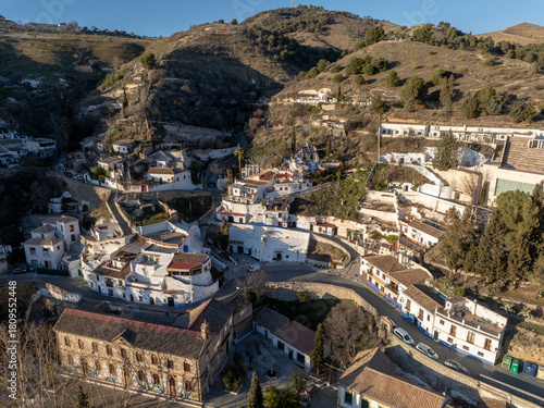 Sacromonte District in Granada, Spain. Aerial drone footage of the Traditional White Caved Dwellings at Sunset Light.