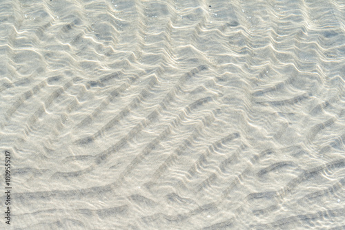 Fototapeta Naklejka Na Ścianę i Meble -  Baltic Sea beach scene showing coastal structures with blue water and soft sand in a peaceful natural area