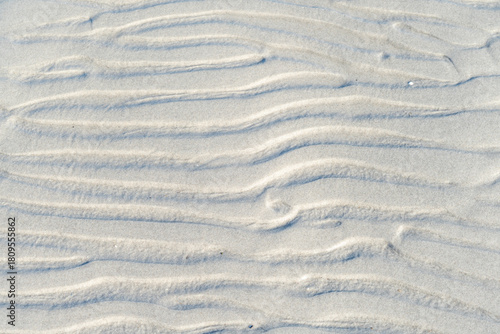 Fototapeta Naklejka Na Ścianę i Meble -  Coastal Baltic Sea structures surrounded by smooth sand and light waves forming a soothing natural beach view