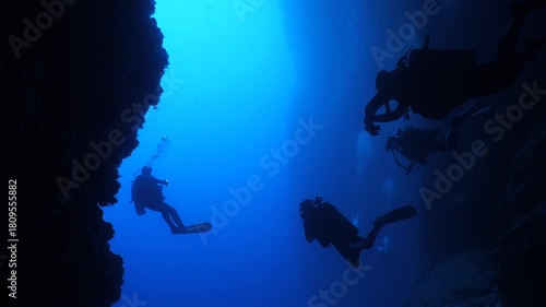 scuba divers are swimming through a channel underwater 