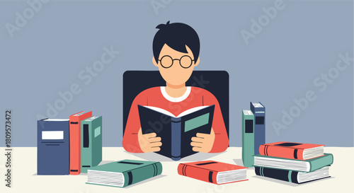 A focused young student wearing glasses is intensively reading a book surrounded by multiple textbooks.
