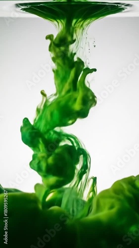 Watch vibrant green ink swirl and dance in water, creating an abstract design that evokes nature and growth in this mesmerizing fluid dynamic display