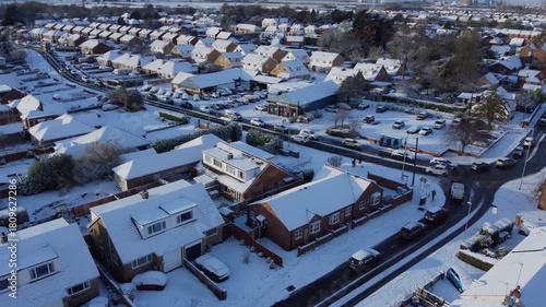 Drone 50fps. UK houses, rooftops covered in snow.  Cold Winter, Christmas season.