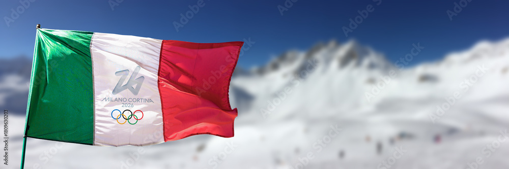 Fototapeta premium 2026 winter olympics Milan Cortina logo, italian flag and snowy mountains in the Alps panoramic background, olympic games header