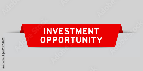 Red color inserted label with word investment opportunity on gray background