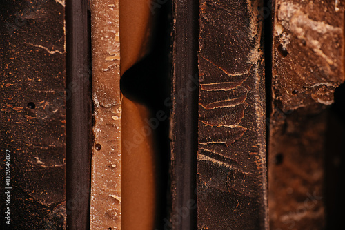 Close-up macro view of assorted chocolate bar edges with layered textures and rich tones, perfect for confectionery branding, dessert advertising, and premium food packaging