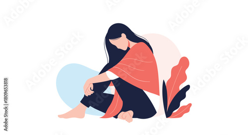 Sad and lonely young woman with long dark hair sits on the floor with her head down feeling depressed and anxious.