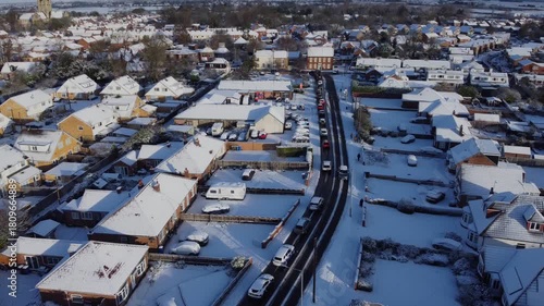 Drone 50fps. UK houses, rooftops covered in snow.  Cold Winter, Christmas season.