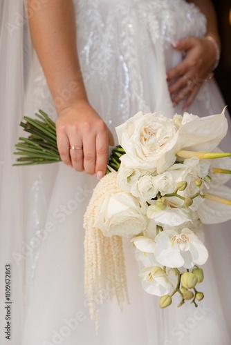 Bridal bouquet highlighting white roses and orchids in an elegant wedding setting