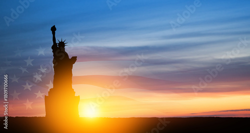 Statue of Liberty with american flag on background of sunset sky. Greeting card for Independence Day. USA celebration.
